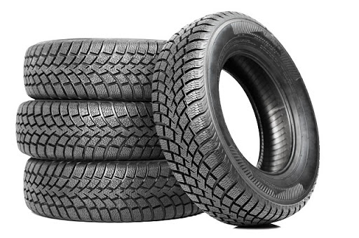 Stack of four car wheel tyres isolated