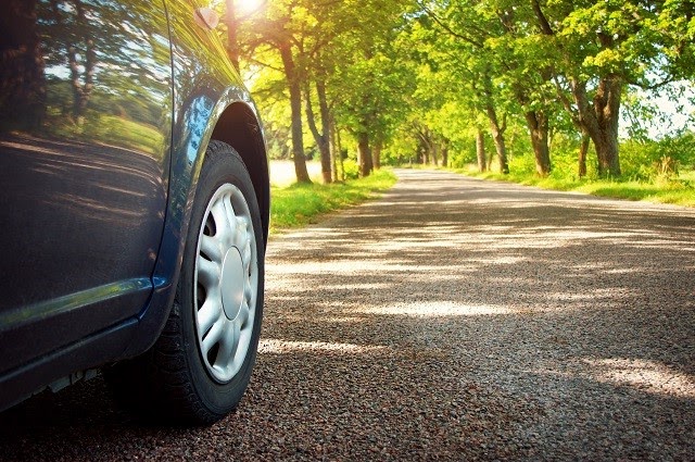 Car on asphalt road in summer.